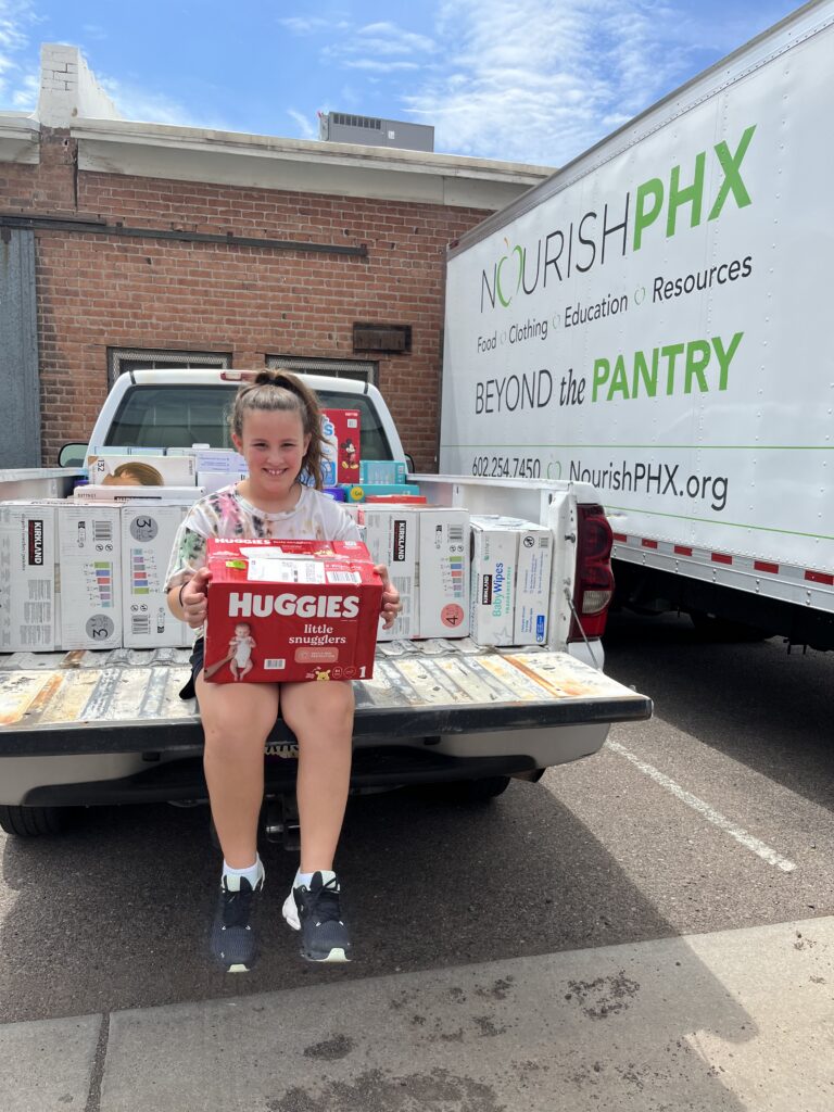 Sloan delivering diapers to Nourish Phoenix in 2022.